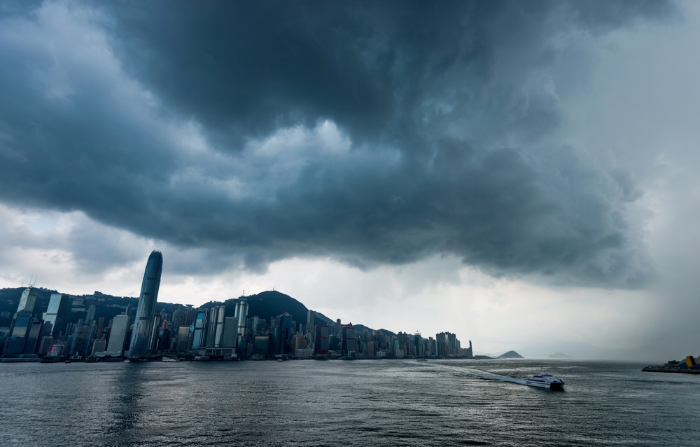 Hong Kong downtown with dark clouds in storm.