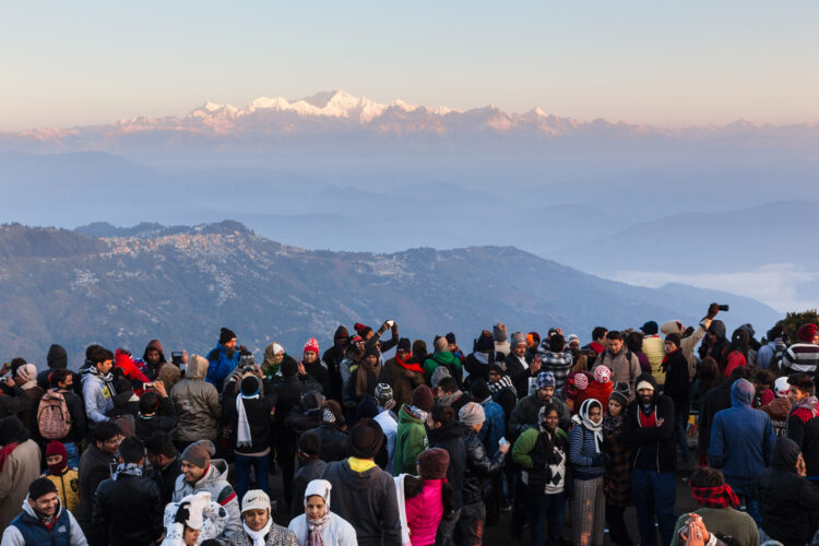 People are seeing the first light of new year's day at dawn with mountain villages and Kangchenjunga mountain in winter at Tiger Hill, Darjeeling. India.