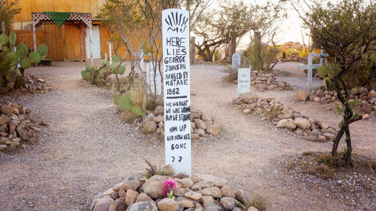 "Quirky old western cemetery with humorous tombstones at a roadside desert attraction capturing the unique spirit of the Wild West, perfect for unconventional historical exploration — visit for a taste of frontier life"