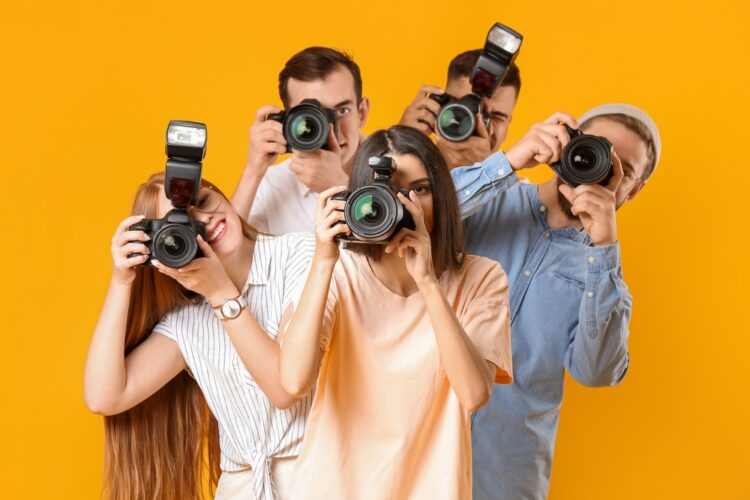 Group of people holding cameras to their eyes