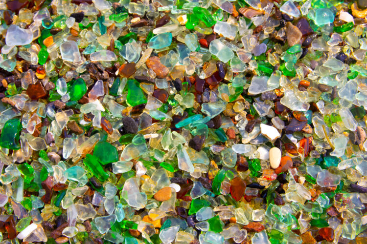 Colorful pieces of glass lying on the beach at Glass Beach, California