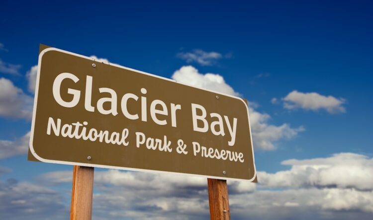 Glacier Bay National Park and Preserve (Alaska) Road Sign Against Blue Sky and Clouds.