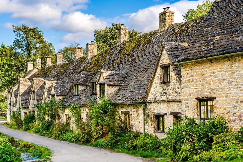 stone cottage houses on Arlington Row in Bibury village, Gloucestershire, The Cotswolds, England UK