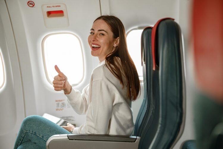 10 Ways to Be a Considerate Flyer Cheerful female airline passenger