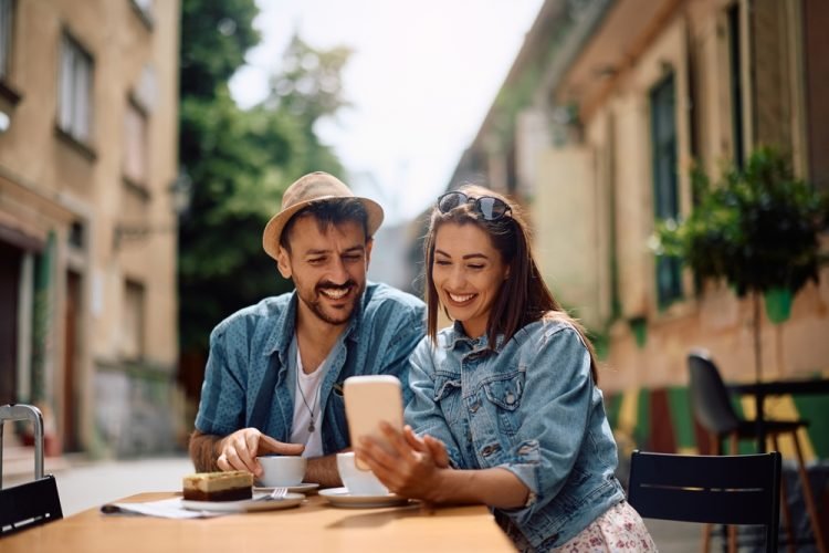 Travel for Two without the Tension Your couple having a treat and looking at cell phone