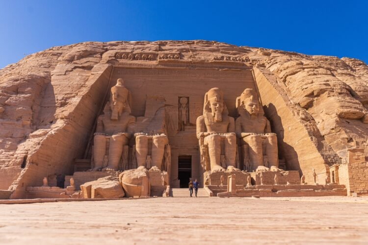 Exterior view of the majestic statues of Ramses II that ornate the facade of the famous Abu Simbel temple