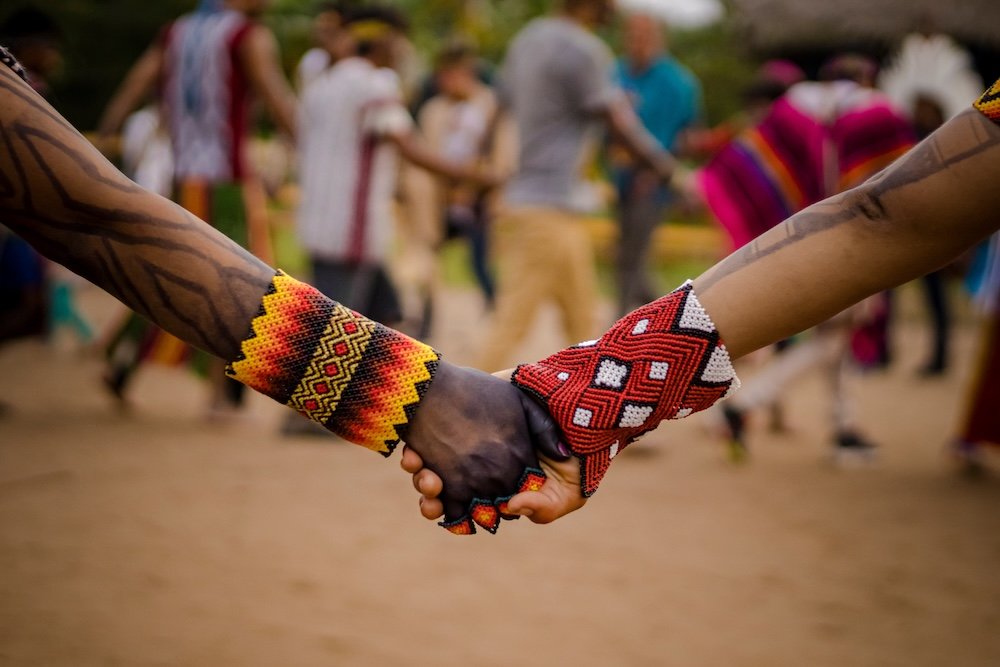 Respecting Sacred Lands Indigenous Peoples holding hands