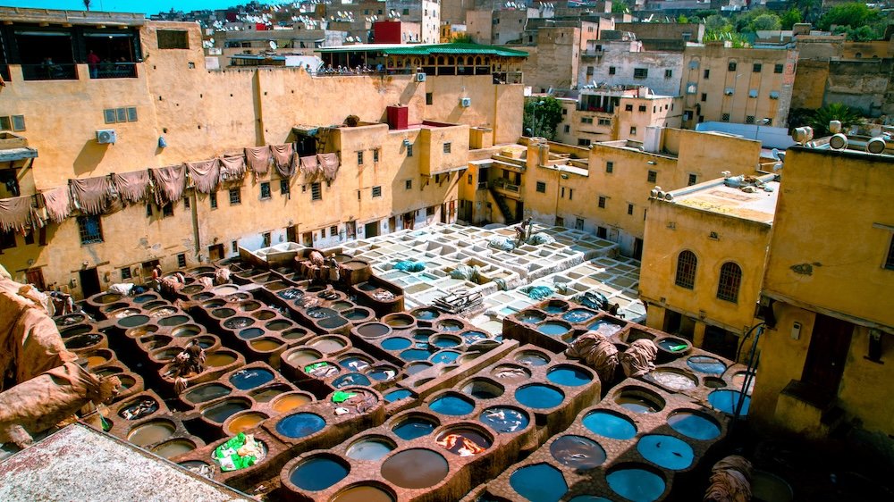 View of the famous tanneries of Fez, with colorful dye pits, sun-drying hide