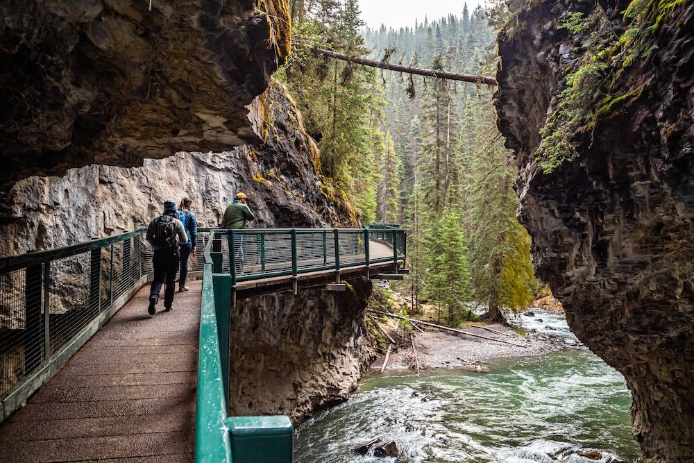 Hikers walk along the Johnston Canyon trail in Banff