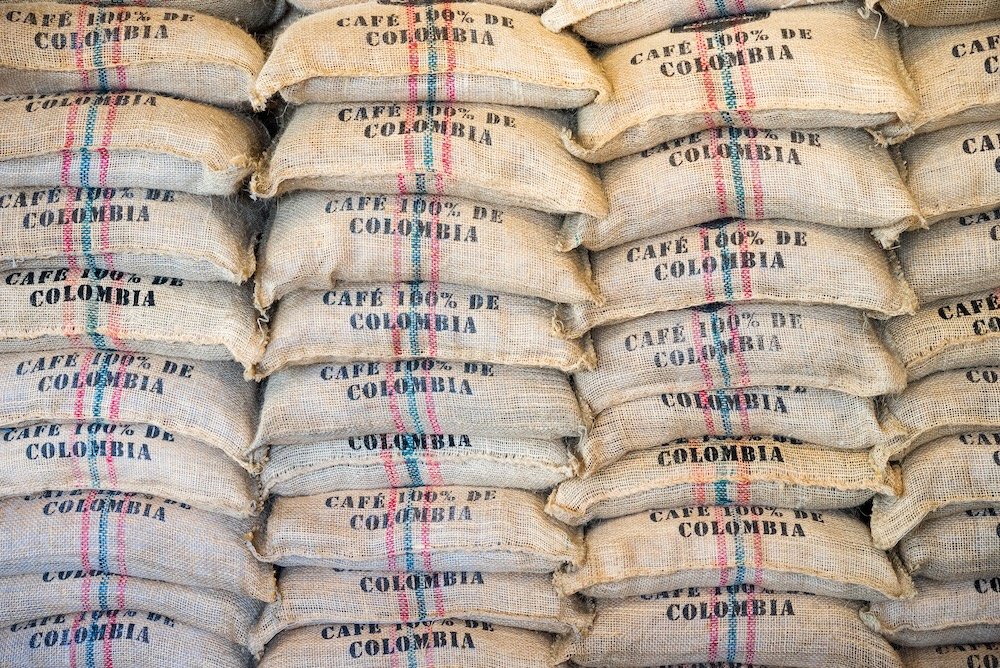 Stack of burlap Columbian coffee bags