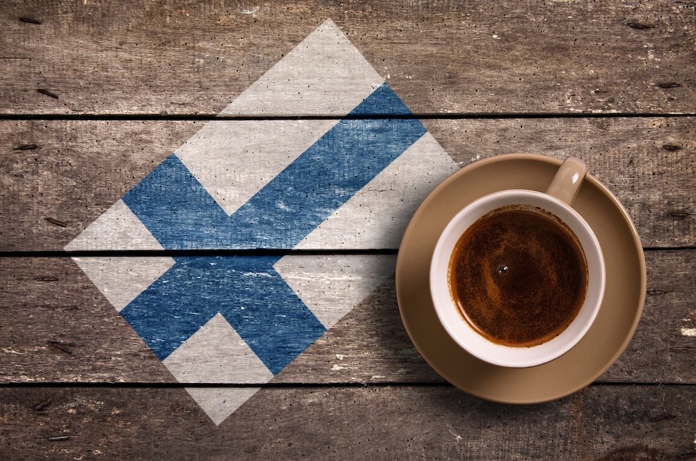 Finland flag with coffee on table